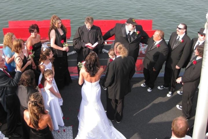 a group of people standing next to a body of water