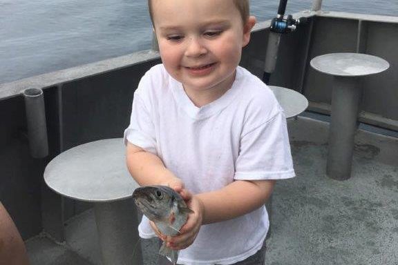 a little boy that is standing in the water