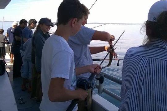 a group of people standing on a boat