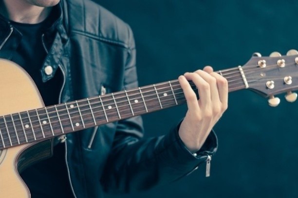 a person holding a guitar